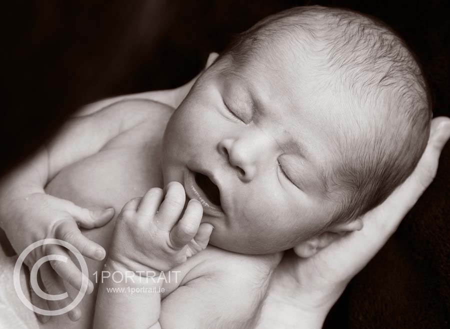 Black and white close up portrait of a newborn in a professional family photography studio Christmas gifts for newborn